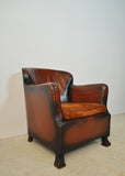 Club chair with original leather from 1920s
